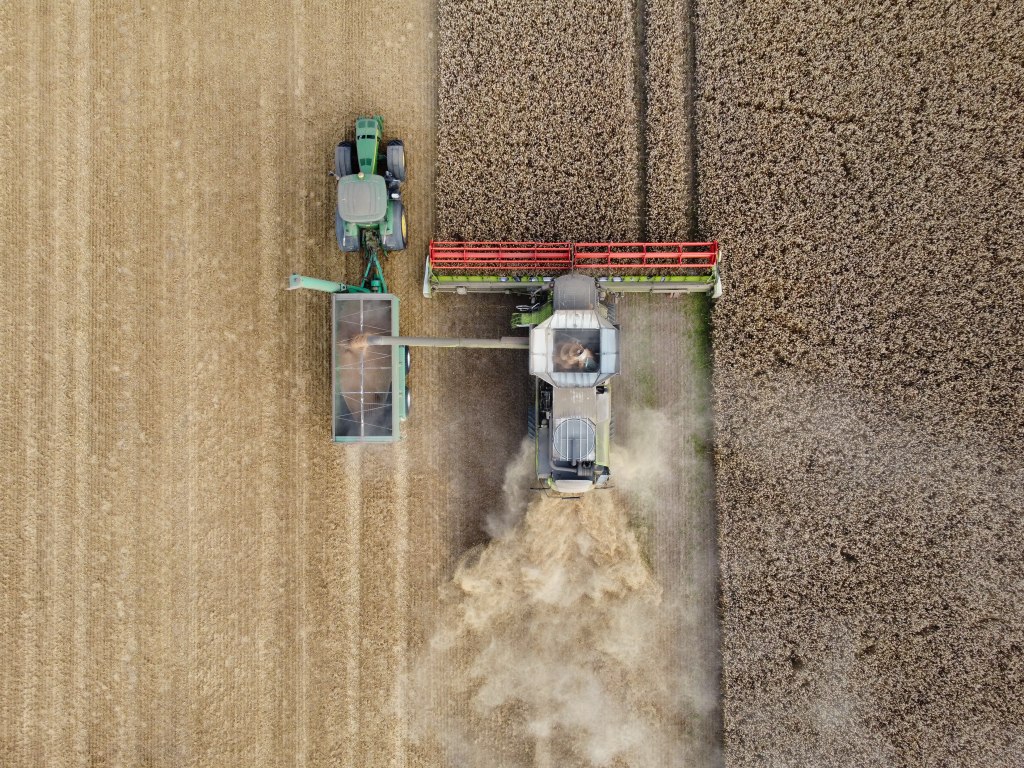 Bild Mähdrescher und Traktor auf einem Feld